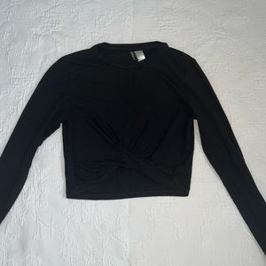 Cropped black long-sleeve top with twist front